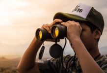 man looking into binoculars