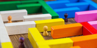People in the maze, finding a way out. The man in the maze. The concept of a business strategy, analytics, search for solutions, the search output. Labyrinth of colorful wooden blocks, tetris.