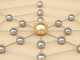 Network concept. Gold sphere in the center, silver spheres are connected by lines.