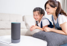 Mom and daughter talk to voice assistant